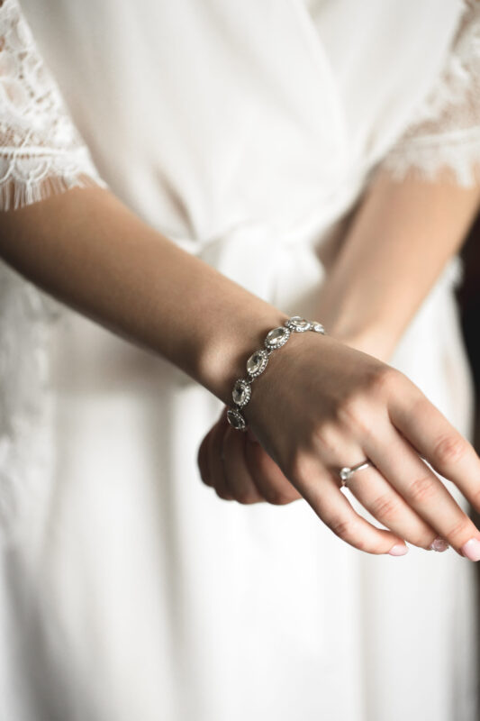 The wedding day. A luxurious bracelet on the bride's hand is a close-up of the bride's hand before the wedding. Wedding accessories.
