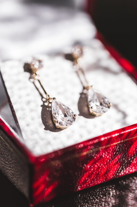 Earrings in a beautiful red gift box in the shining light
